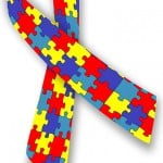 The image shown is the Autism awareness ribbon which features a multi colored jigsaw piece pattern.