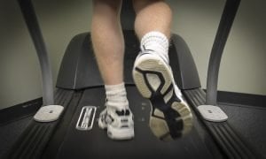 The image shows someone walking on a treadmill.