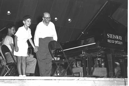 The image shows 11 year old pianist, Danny Barenboim playing at a concert in 1956.