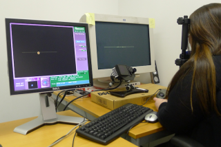 The image shows a participant undergoing an eye tracking experiment.