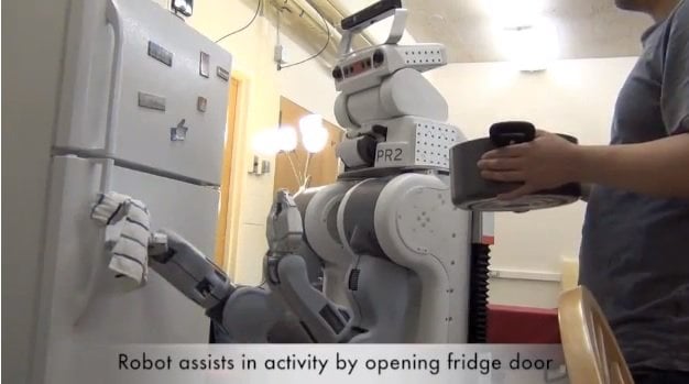 The image shows the robot opening a fridge door.