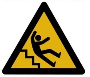 The image shows a caution sign with a person falling down stairs.