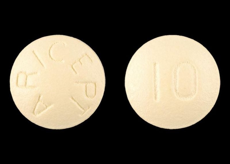 The image shows an Aricept Donepezil Hydrochloride cognitive enhancement pill.