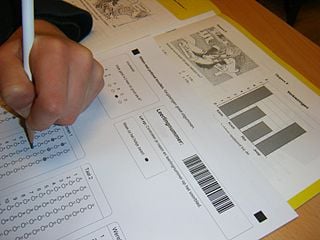 This image shows a person filling in a standardized test sheet.