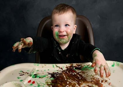 This is a messy baby in a high chair.