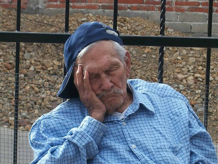 The image shows a old man taking a nap.