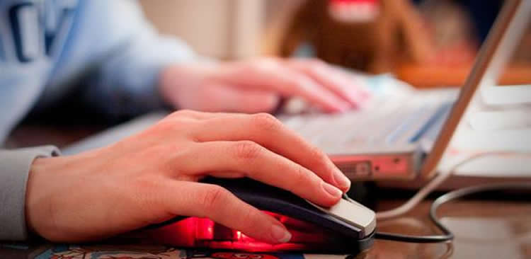 The image shows a person using a computer mouse.