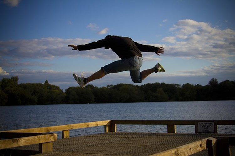 This image shows a man leaping up, as if hurdling.