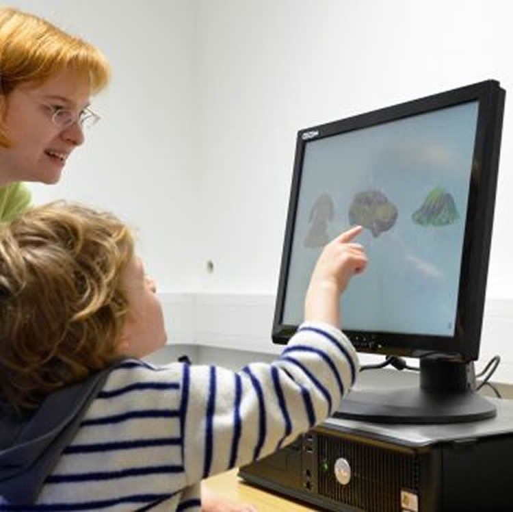 This image shows the researcher and a child looking at a computer screen.