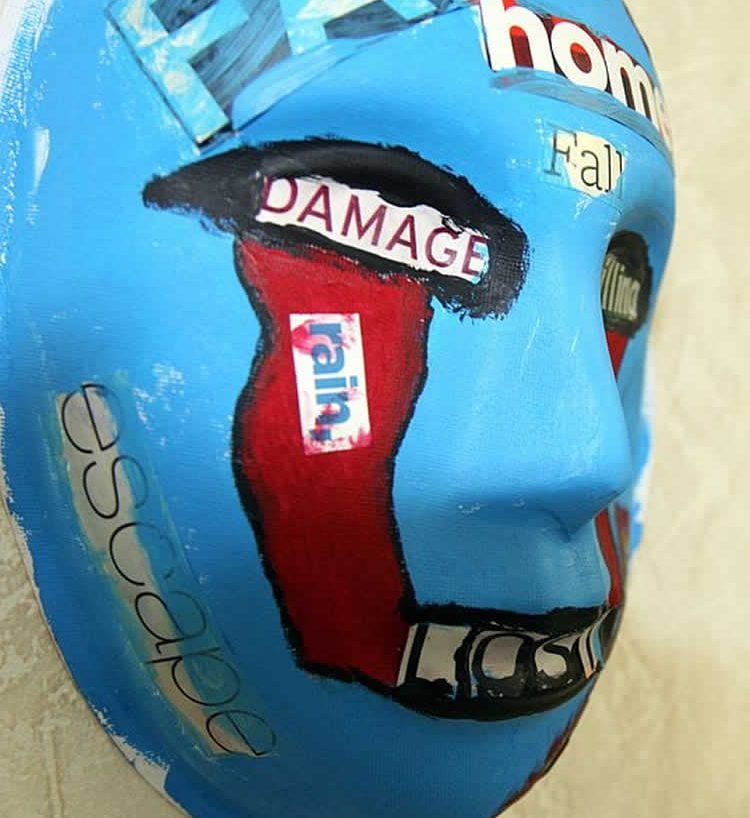 The image shows a mask, painted by a U.S. Marine who attended art therapy to relieve PTSD symptoms.