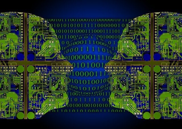 This image shows binary computer code in blue and the outline of two heads.