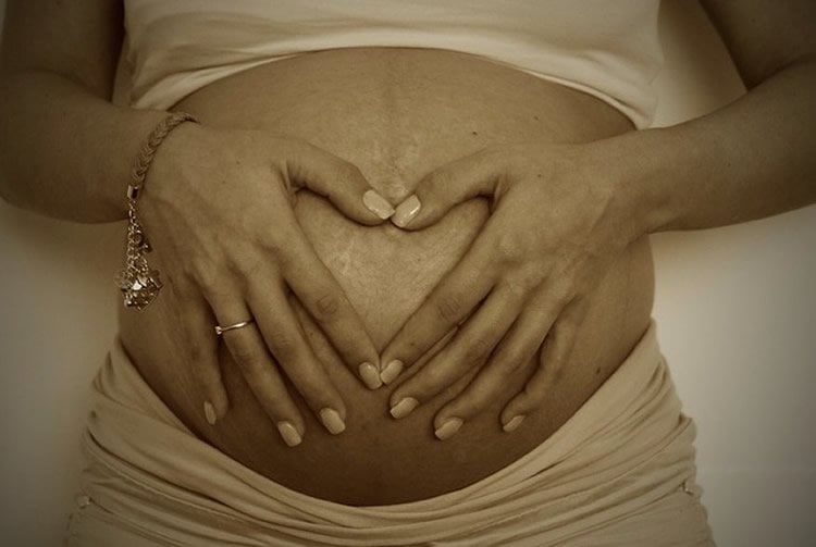 This image shows a woman with a pregnant belly.
