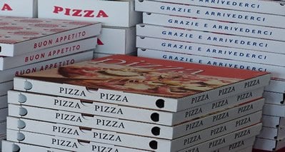 This image shows pizza boxes stacked.