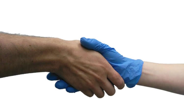 This shows people shaking hands. One has a blue rubber glove on.