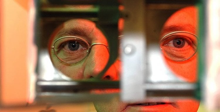 This image shows the researcher looking through the equipment he used to test binocular rivalry.