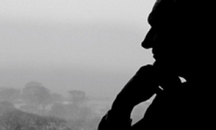 Image of a man sitting by a window.