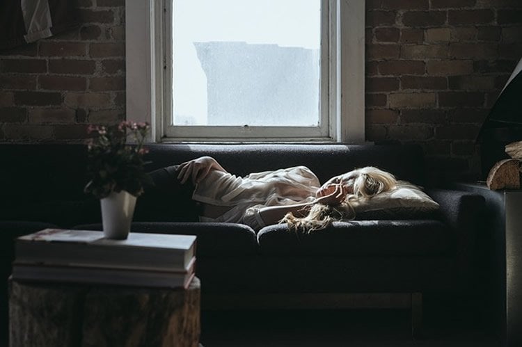Image of a woman sleeping on a sofa.