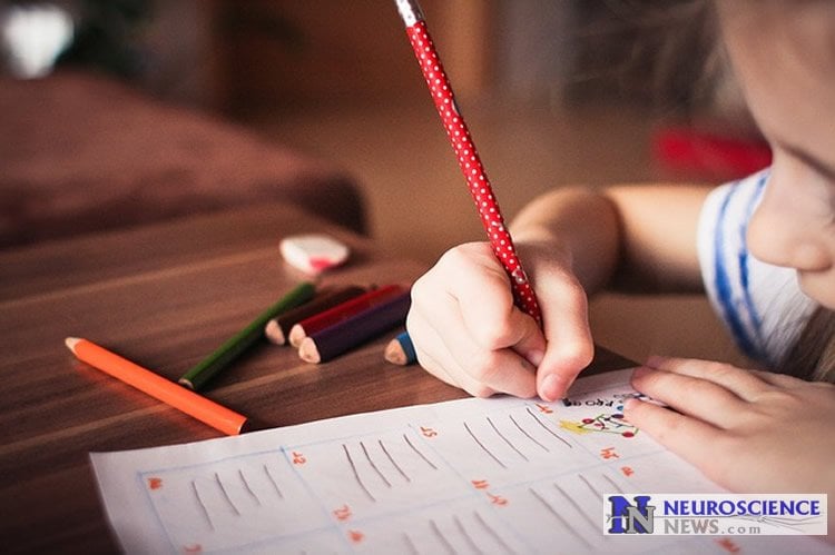 Image shows a child doing school work.