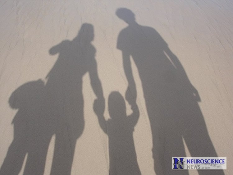Image shows a family in shadows.