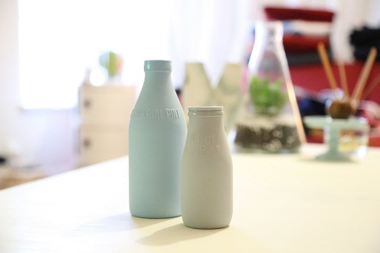 Image shows old fashioned milk bottles.