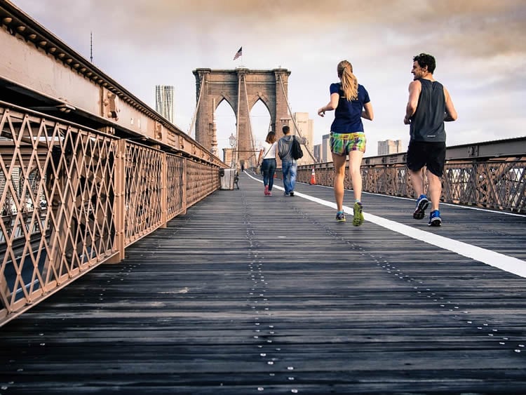 Image shows a man and woman running.