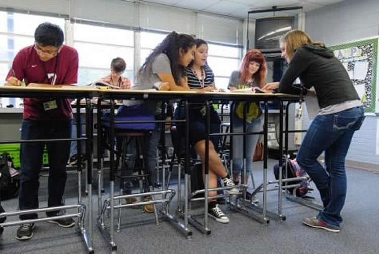 Image shows students studying at standing desks.