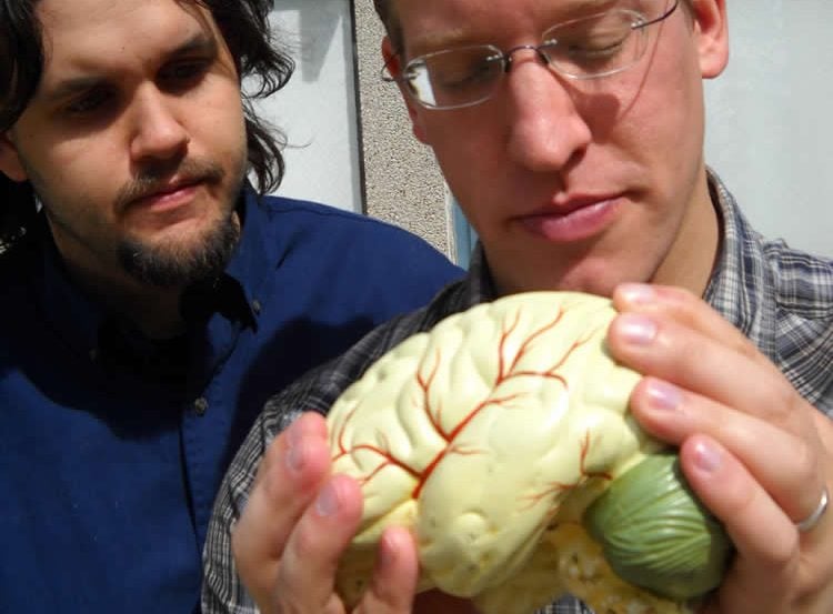 Image shows the researchers holding a brain.