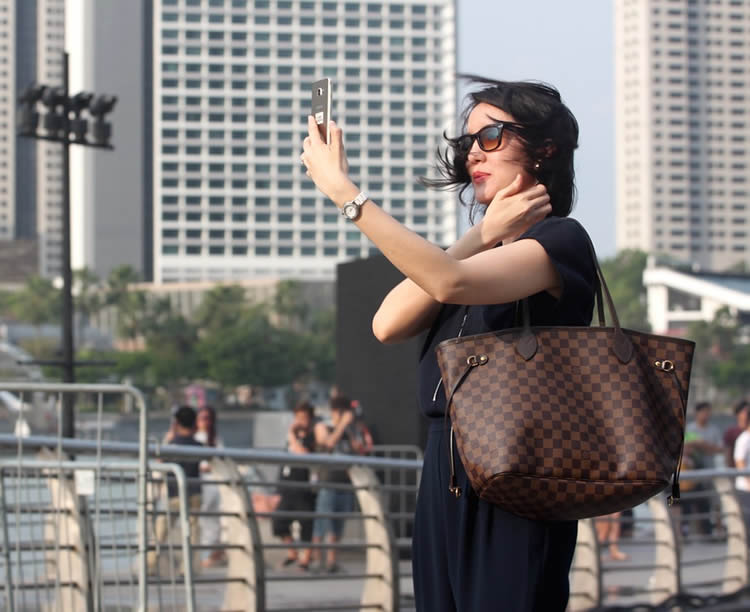 Photo of a woman posing for a selfie.