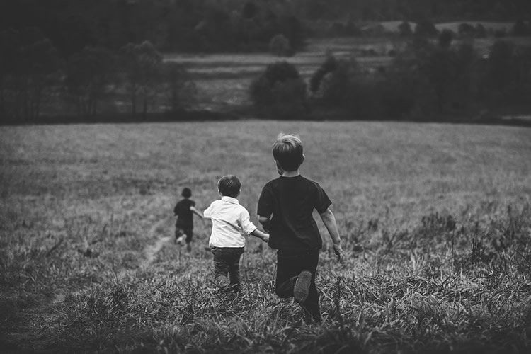 Image shows kids running in a field.