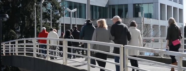 Image shows a group of people walking.