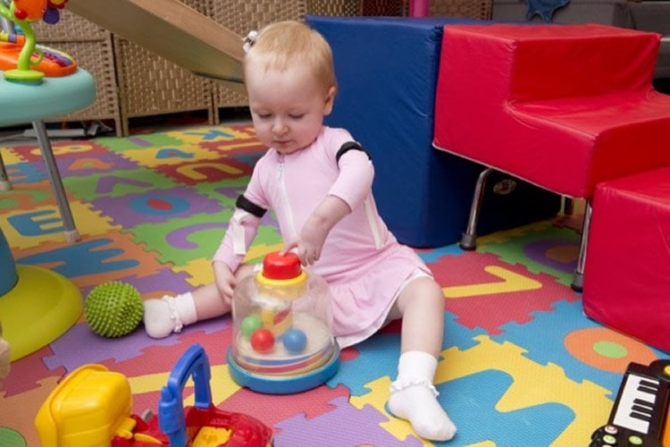 Image shows a child playing while wearing a suit.