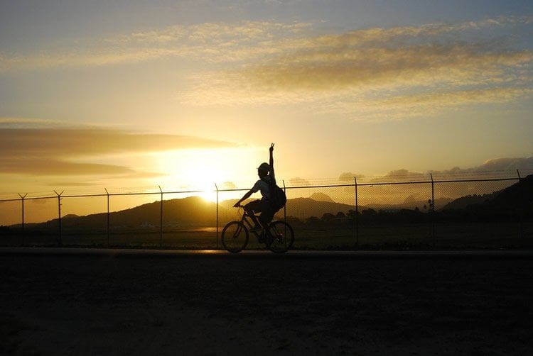 Image shows a person riding a bike.