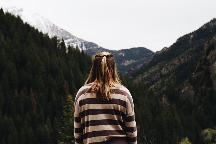 Image shows a woman standing alone.