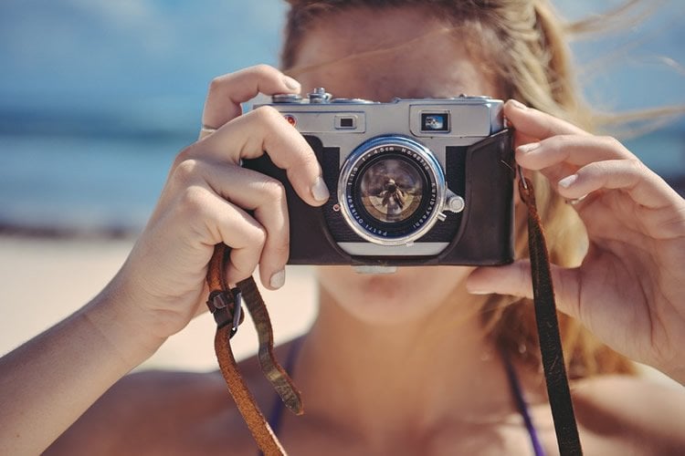 Image shows a woman taking a photo.