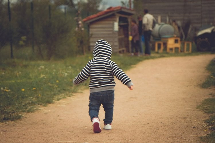 Image shows a baby walking.