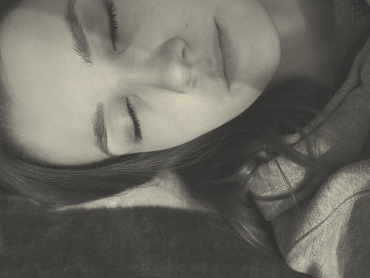 Image shows a woman sleeping.
