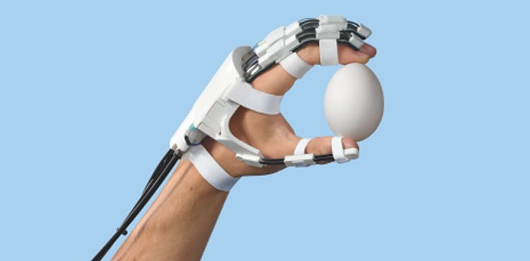 Image shows hand in an exoskeleton holding an egg.