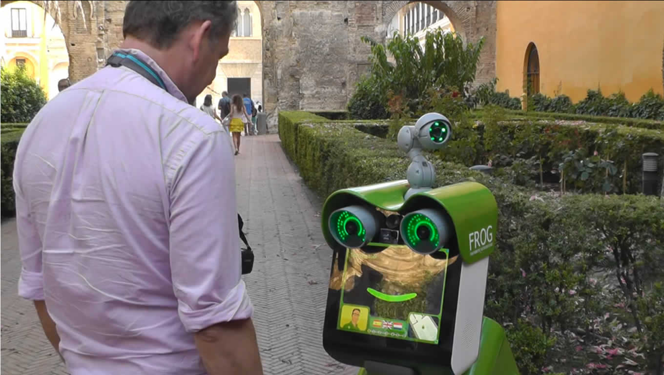 Image shows a man interacting with the FROG robot.