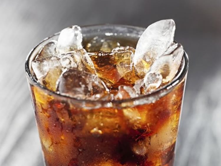 Image shows a glass of soda.