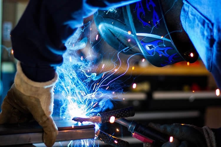 Image shows a person welding.