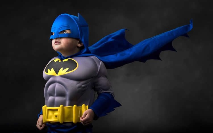 Image shows a boy in a Batman costume.
