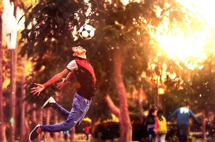 Image shows a person heading a soccer ball.