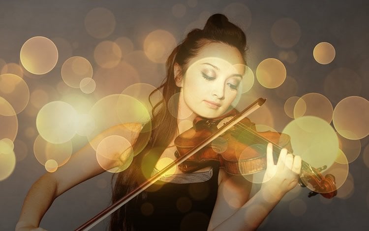 Image shows a woman playing the violin.