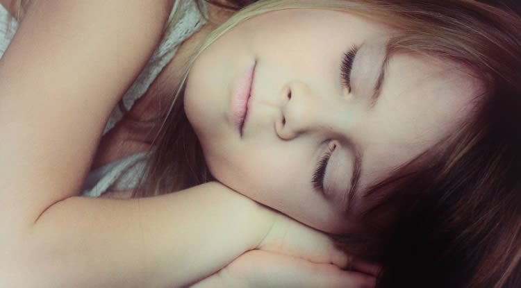 Image shows a sleeping little girl.