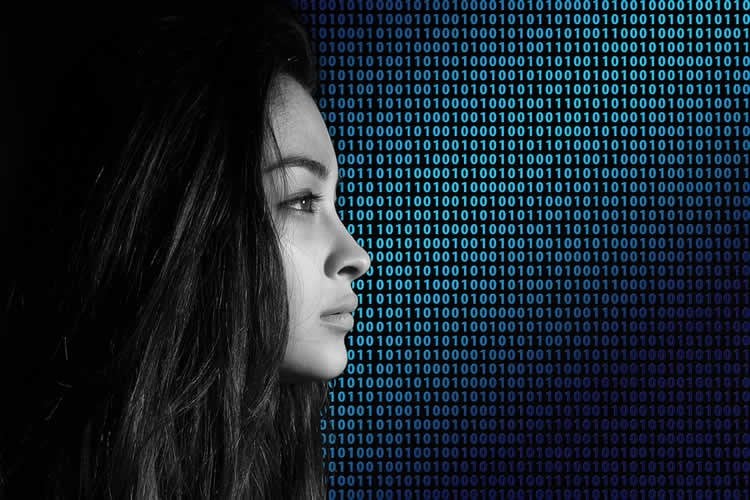 Image shows a woman and binary code.