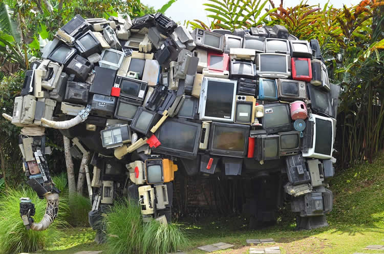 Image shows an elephant statue made of tv's.