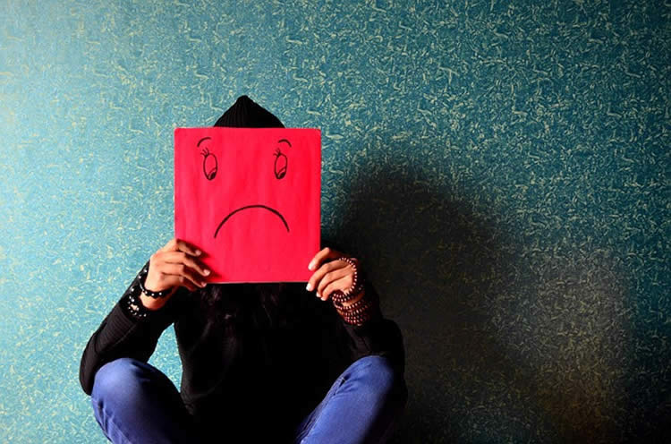 Image shows a person with depression.