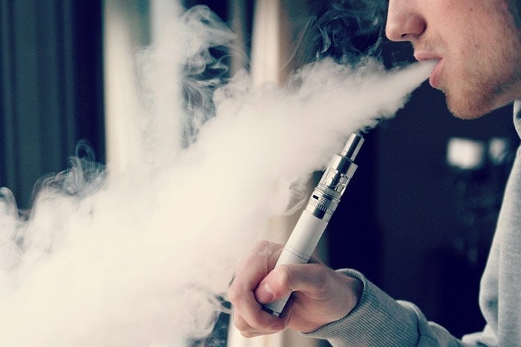 Image shows a teen smoking a cannabis vape.