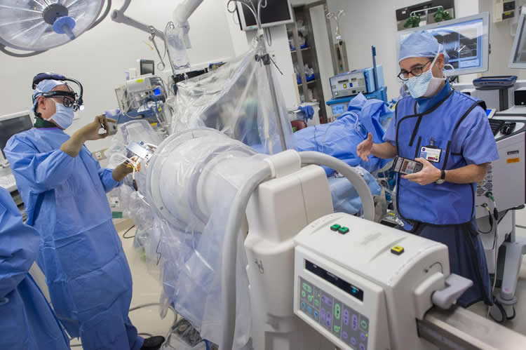 Image shows surgeons implanting a DBS device into a person with tourette.