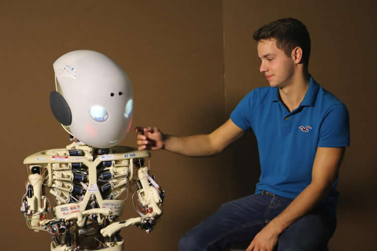 Image shows a man and Roboy the robot.